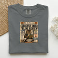 Currently Under Feline Review graphic tee in Pepper, folded mockup
