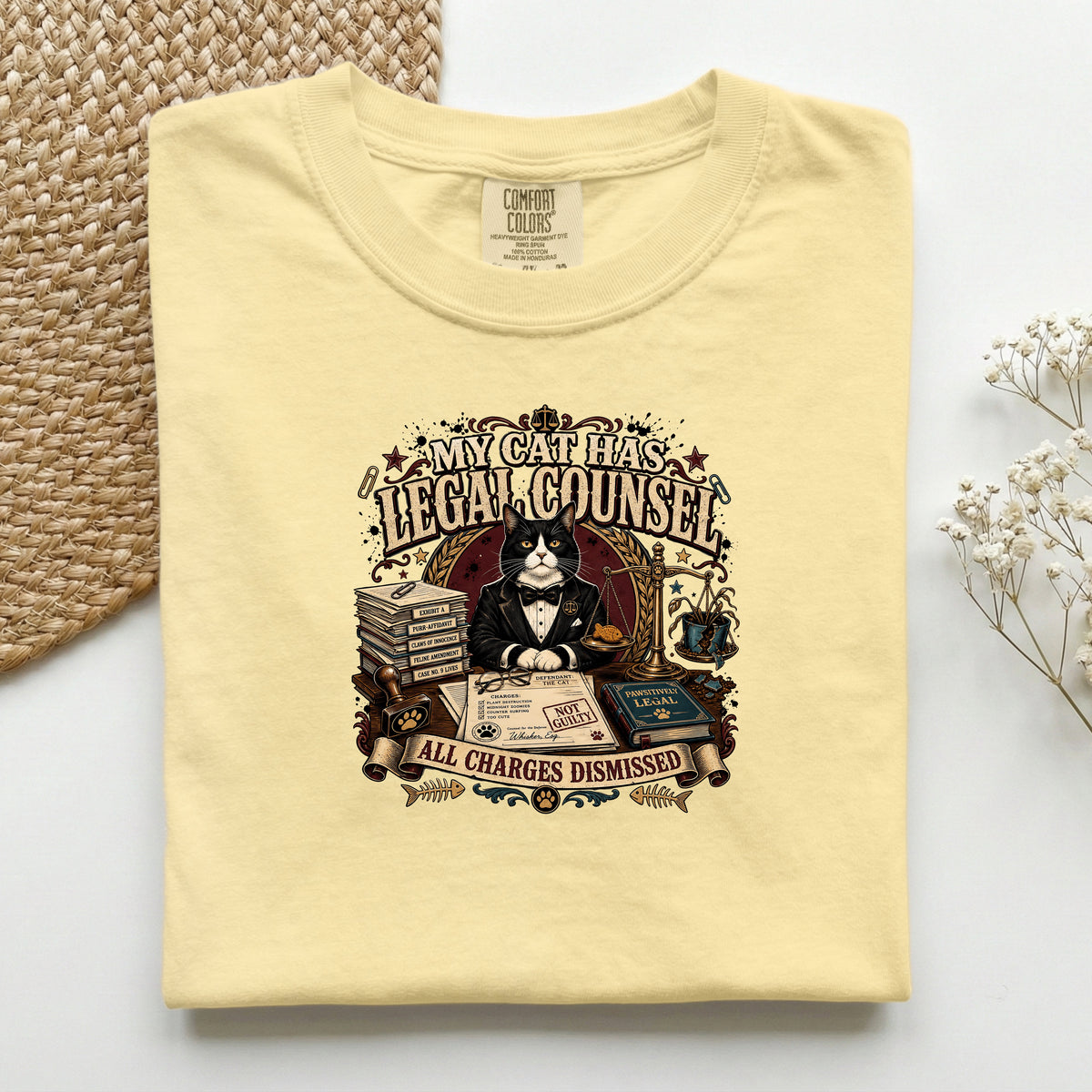 My Cat Has Legal Counsel graphic tee in Butter, folded mockup