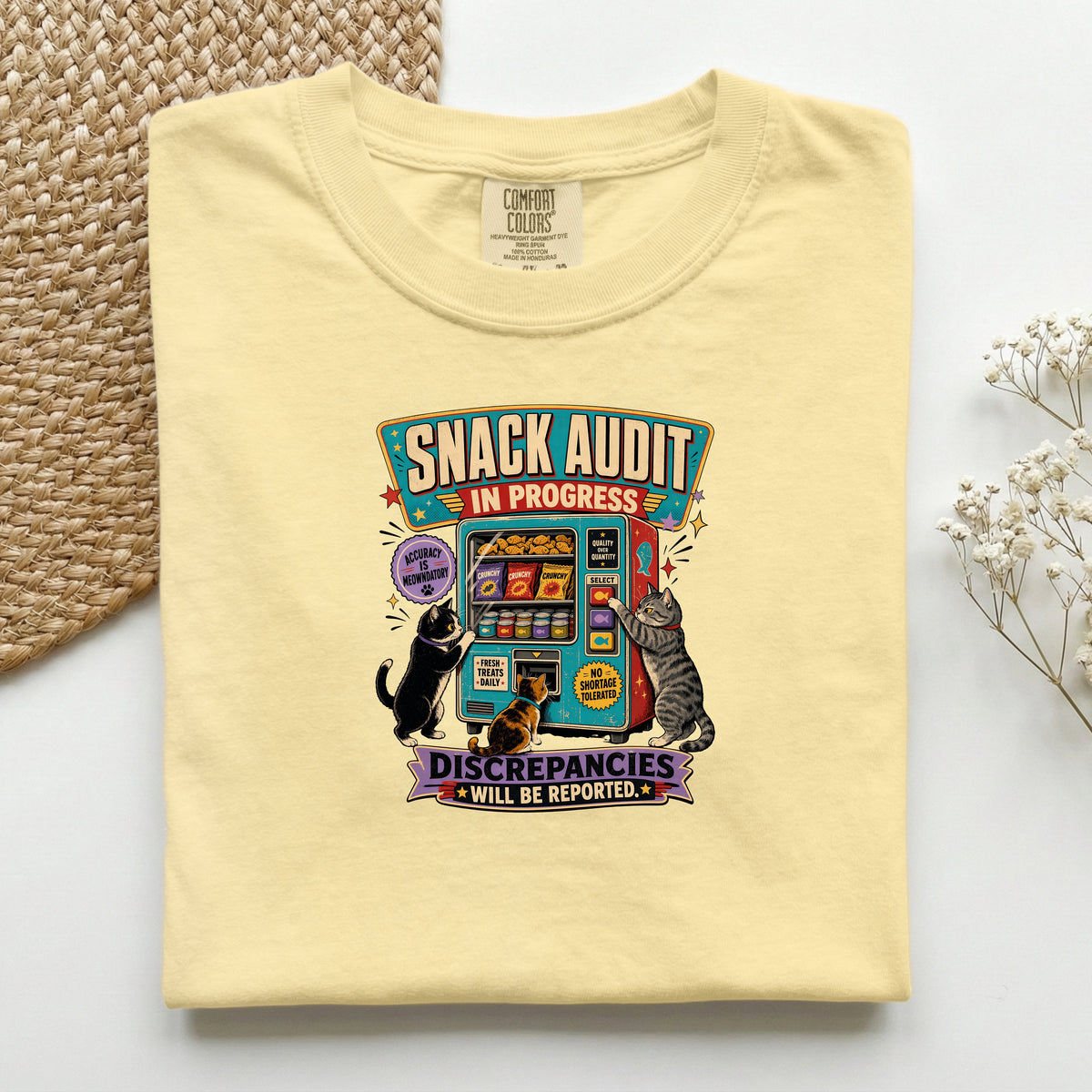 Snack Audit In Progress graphic tee in Butter, folded mockup