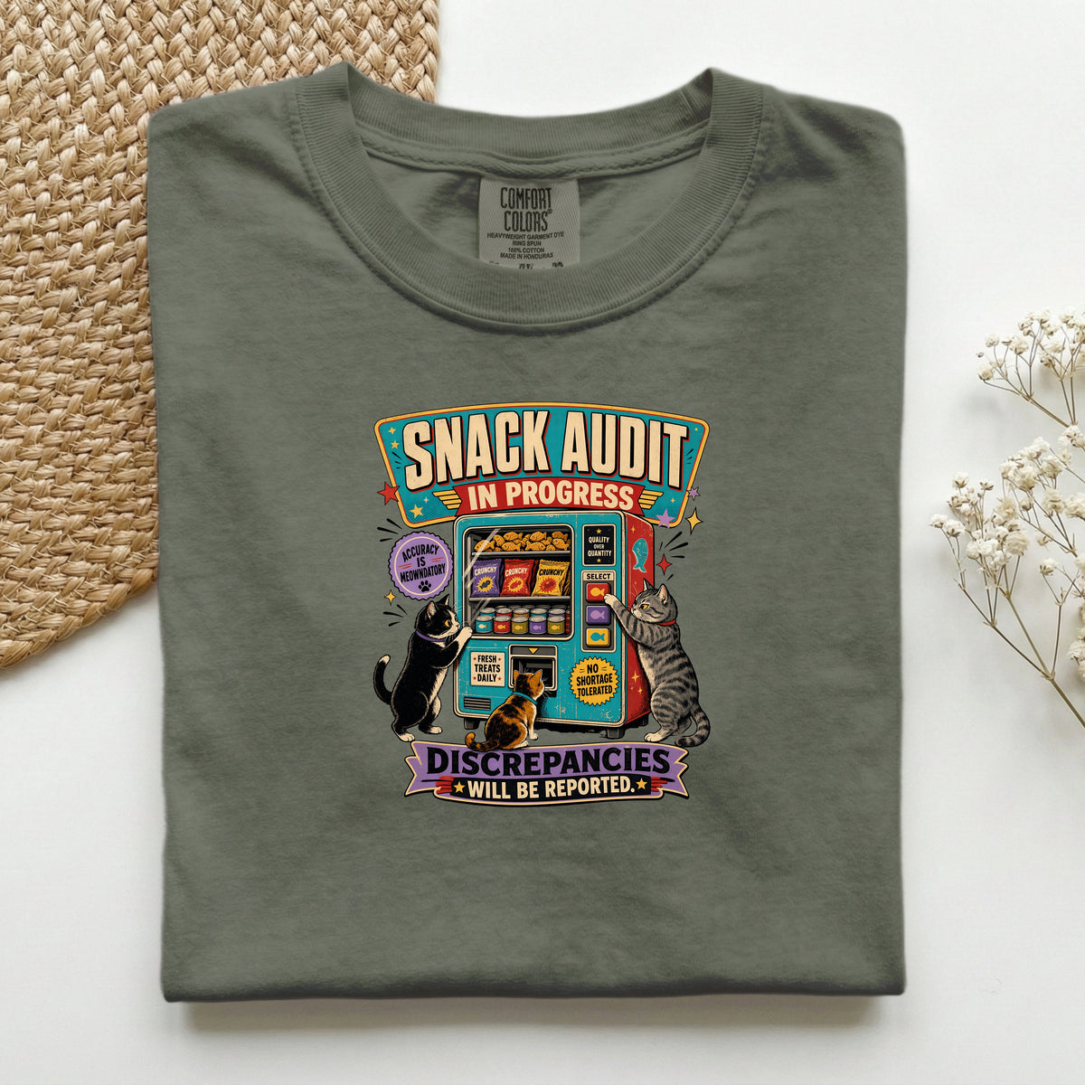 Snack Audit In Progress graphic tee in Moss, folded mockup