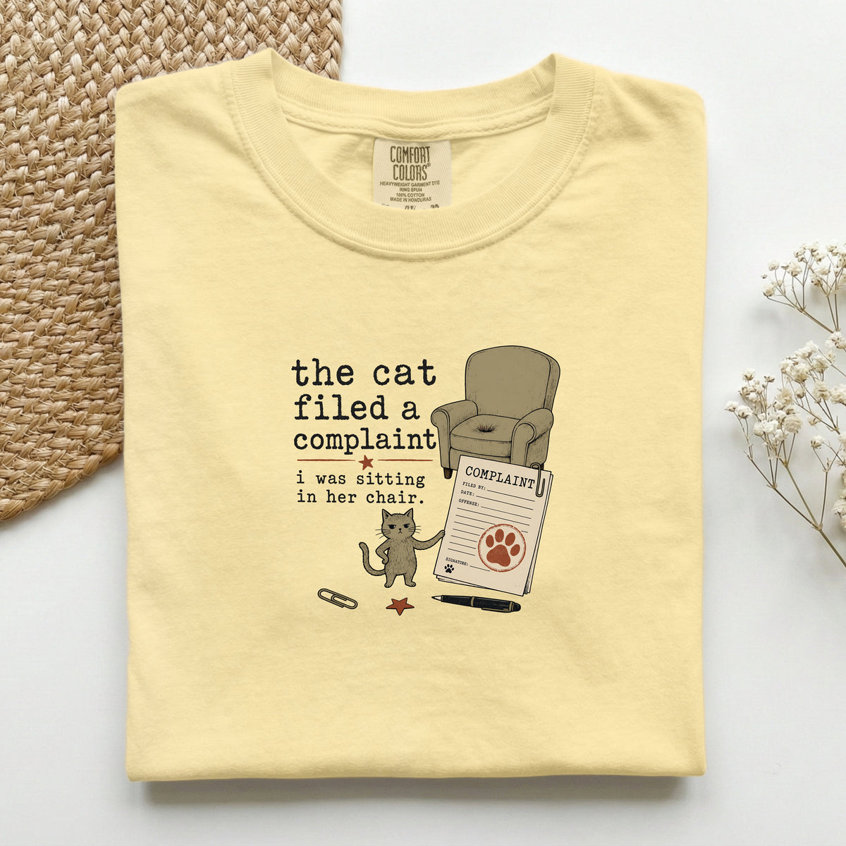 The Cat Filed A Complaint graphic tee in Butter, folded mockup