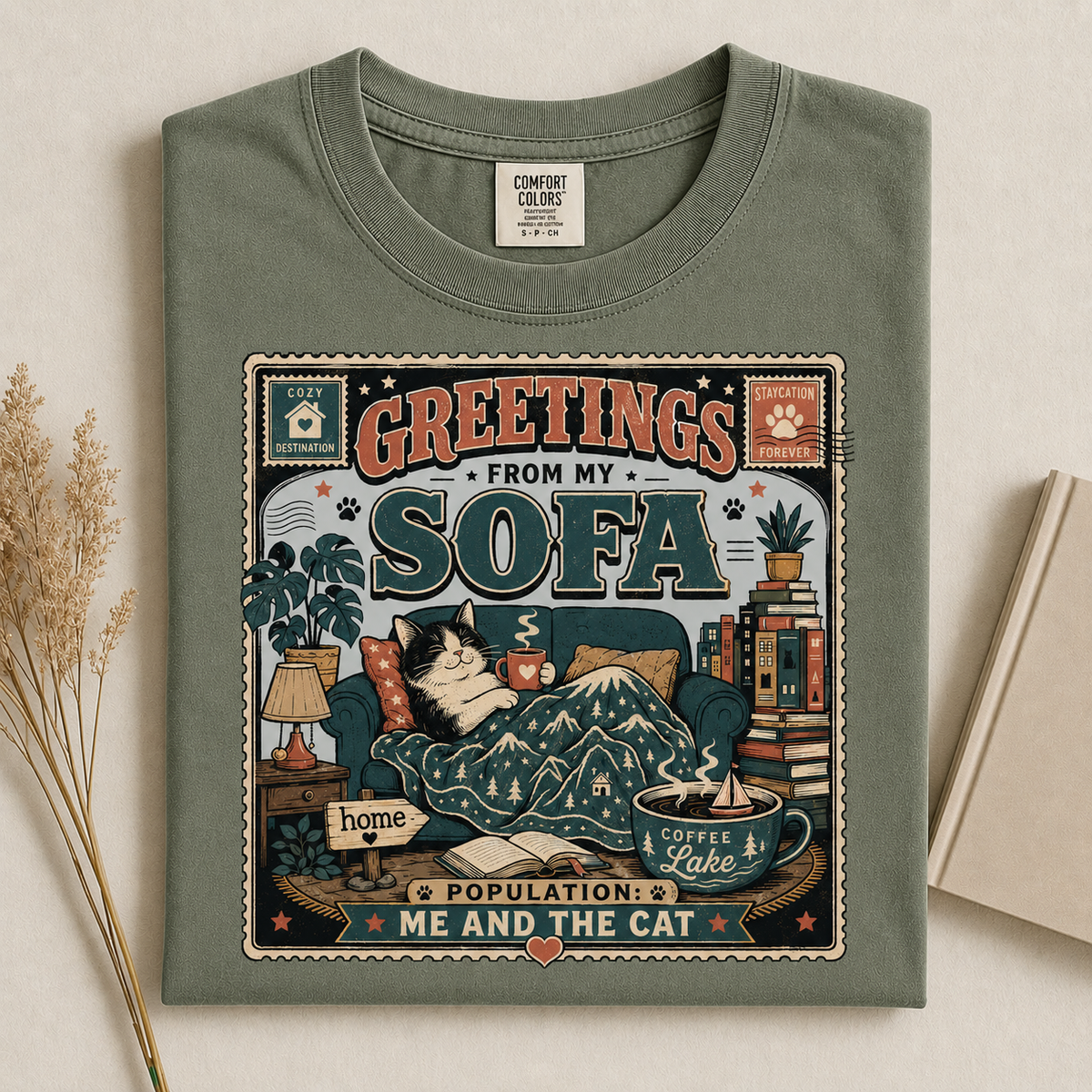 Greetings From My Sofa graphic tee in Moss, folded flat lay