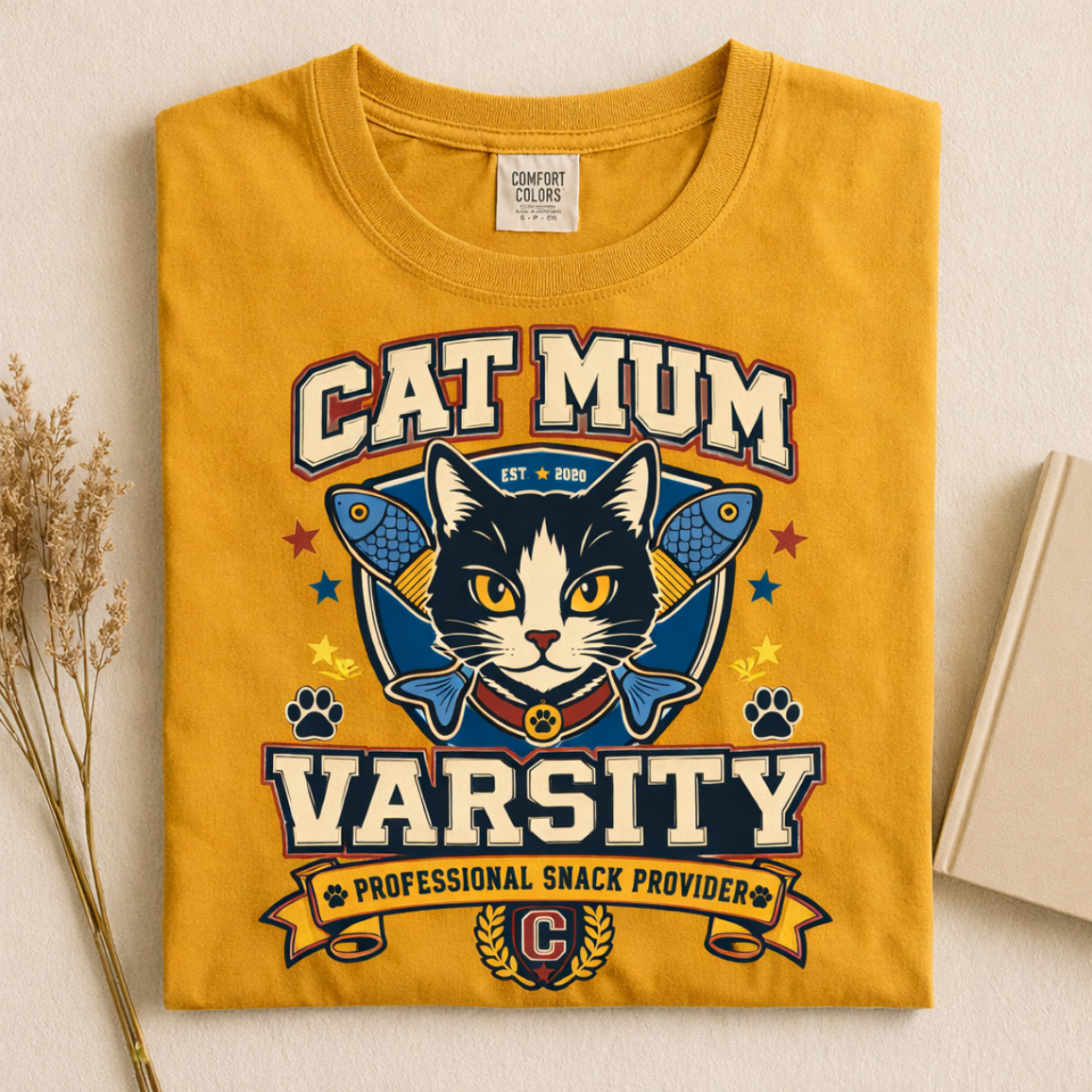 Cat Mum Varsity graphic tee in Mustard, folded flat lay