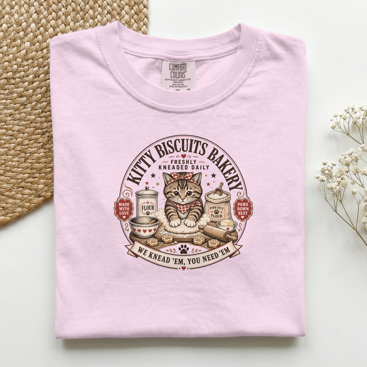 Kitty Biscuits Bakery graphic tee in Blossom, folded flat lay