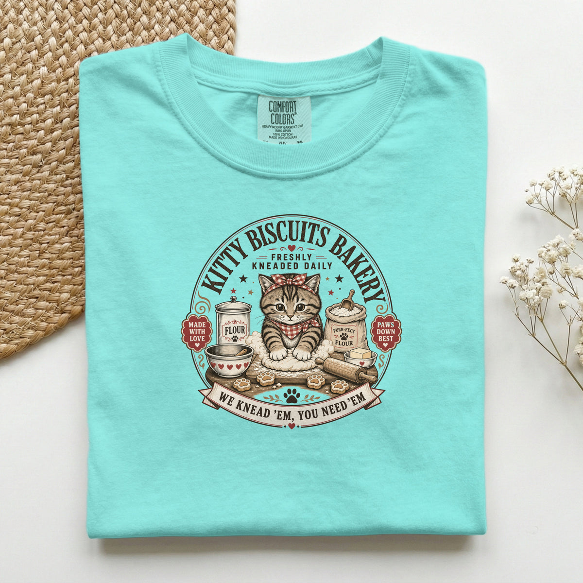 Kitty Biscuits Bakery graphic tee in Chalky Mint, folded flat lay