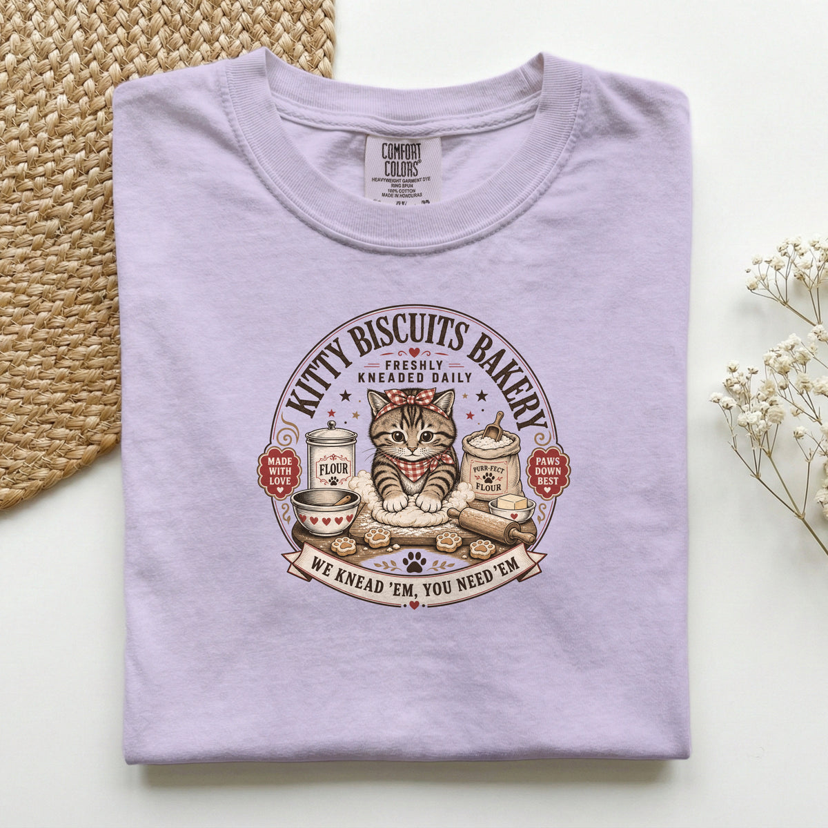 Kitty Biscuits Bakery graphic tee in Orchid, folded flat lay