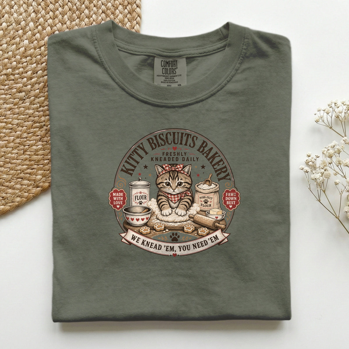 Kitty Biscuits Bakery graphic tee in Moss, folded flat lay