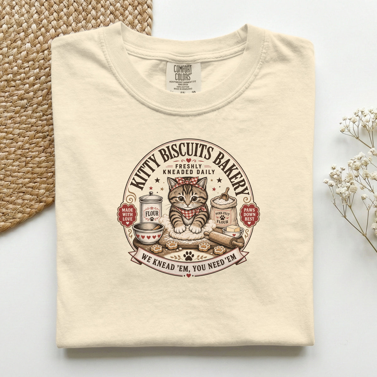 Kitty Biscuits Bakery graphic tee in Ivory, folded flat lay