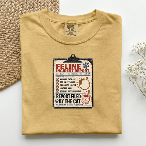 Feline Incident Report graphic tee in Black, folded flat lay
