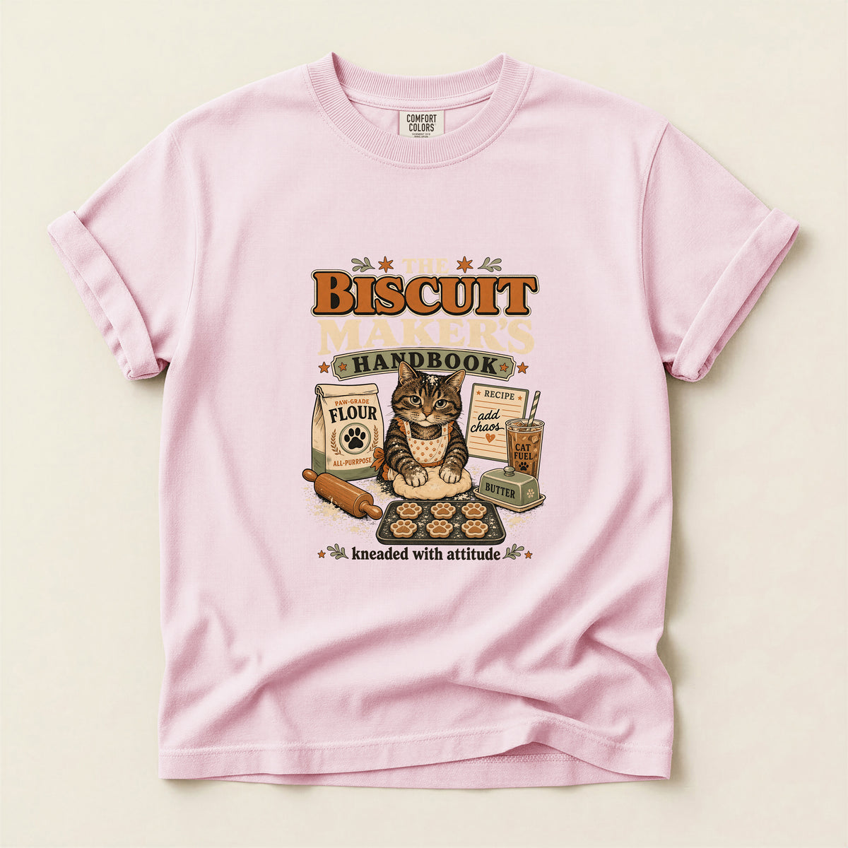 The Biscuit Maker's Handbook graphic tee in Blossom, folded flat lay