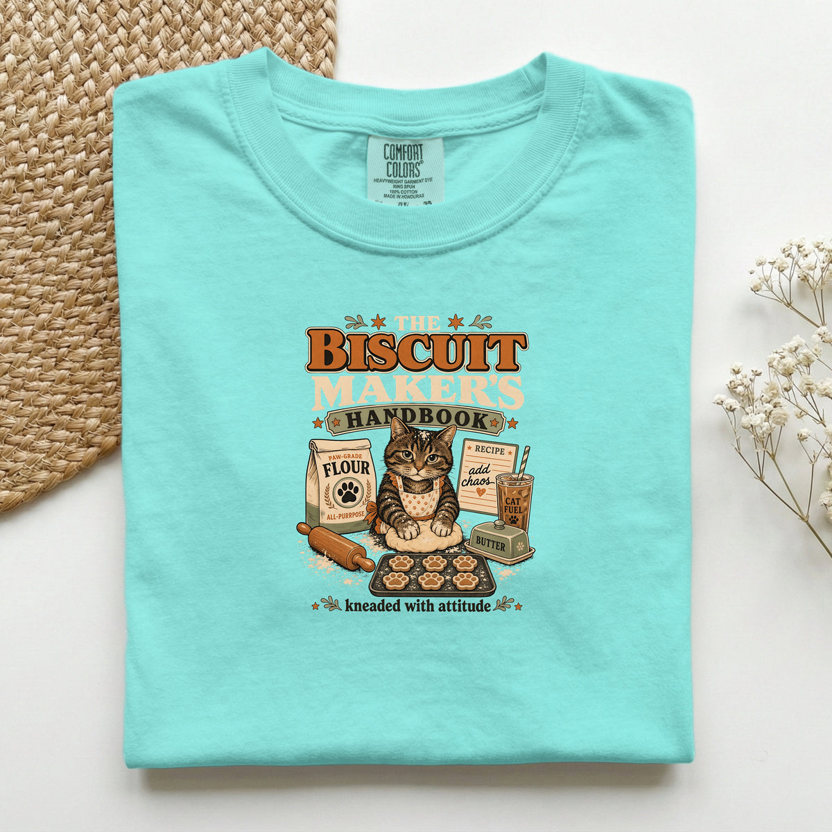 The Biscuit Maker's Handbook graphic tee in Chalky Mint, folded flat lay