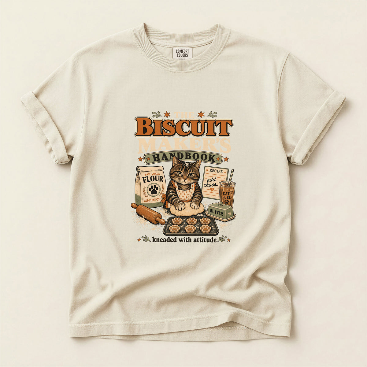 The Biscuit Maker's Handbook graphic tee in Ivory, folded flat lay