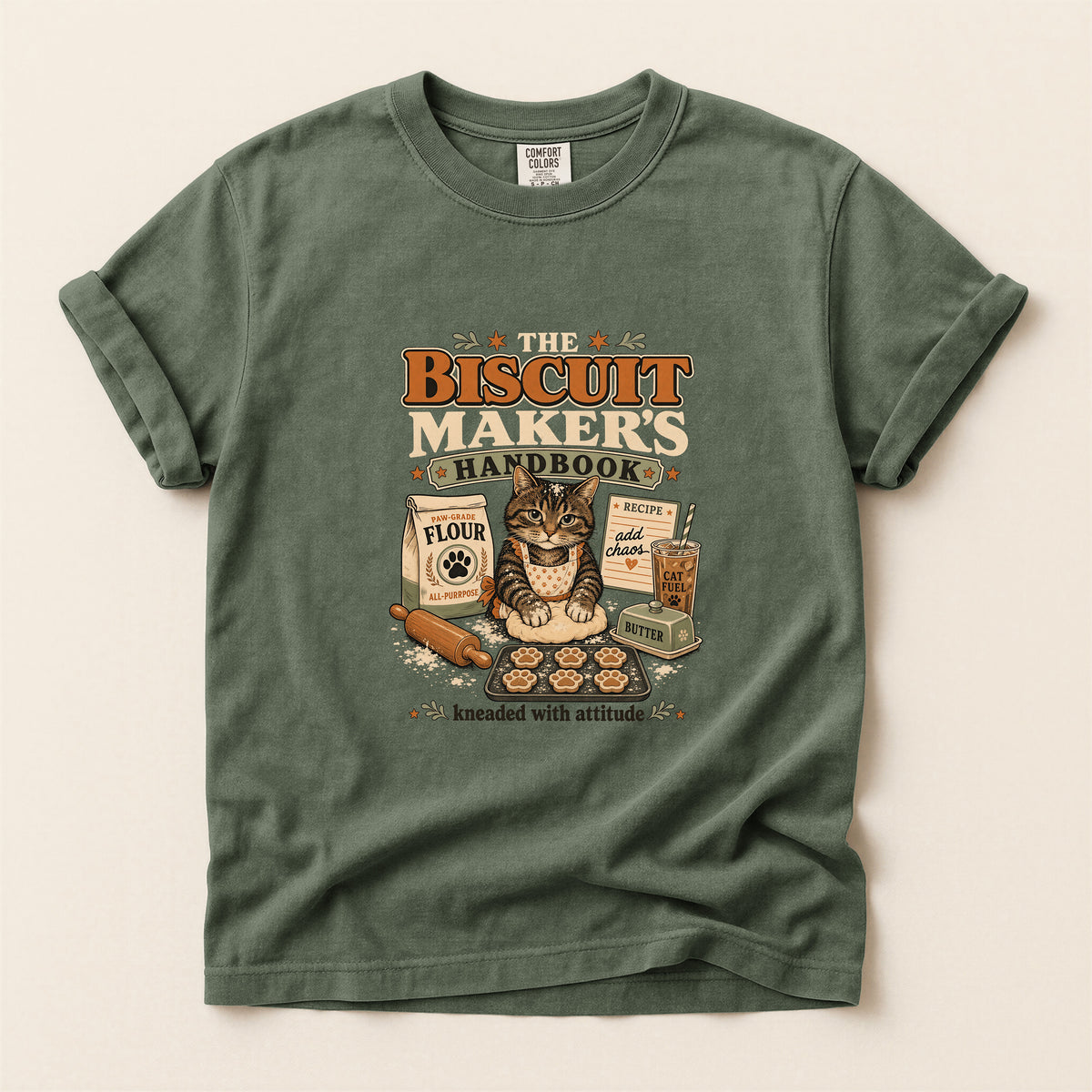 The Biscuit Maker's Handbook graphic tee in Moss, folded flat lay