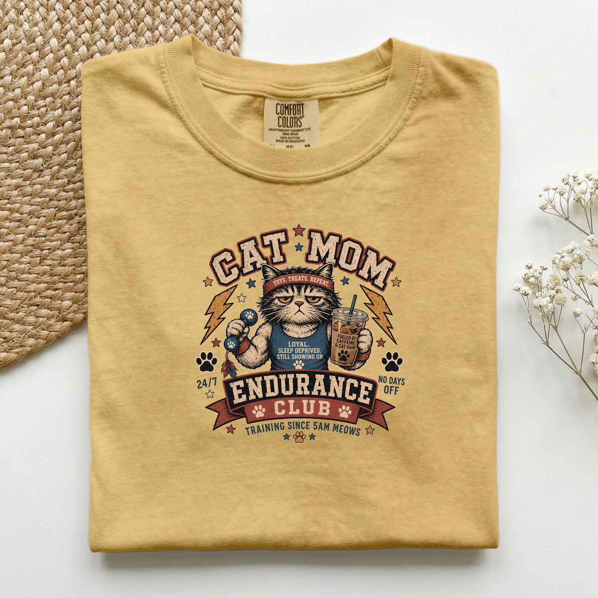 Cat Mom Endurance Club graphic tee in Mustard, folded flat lay