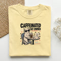 Caffeinated and Cat Owned graphic tee in Butter, folded flat lay