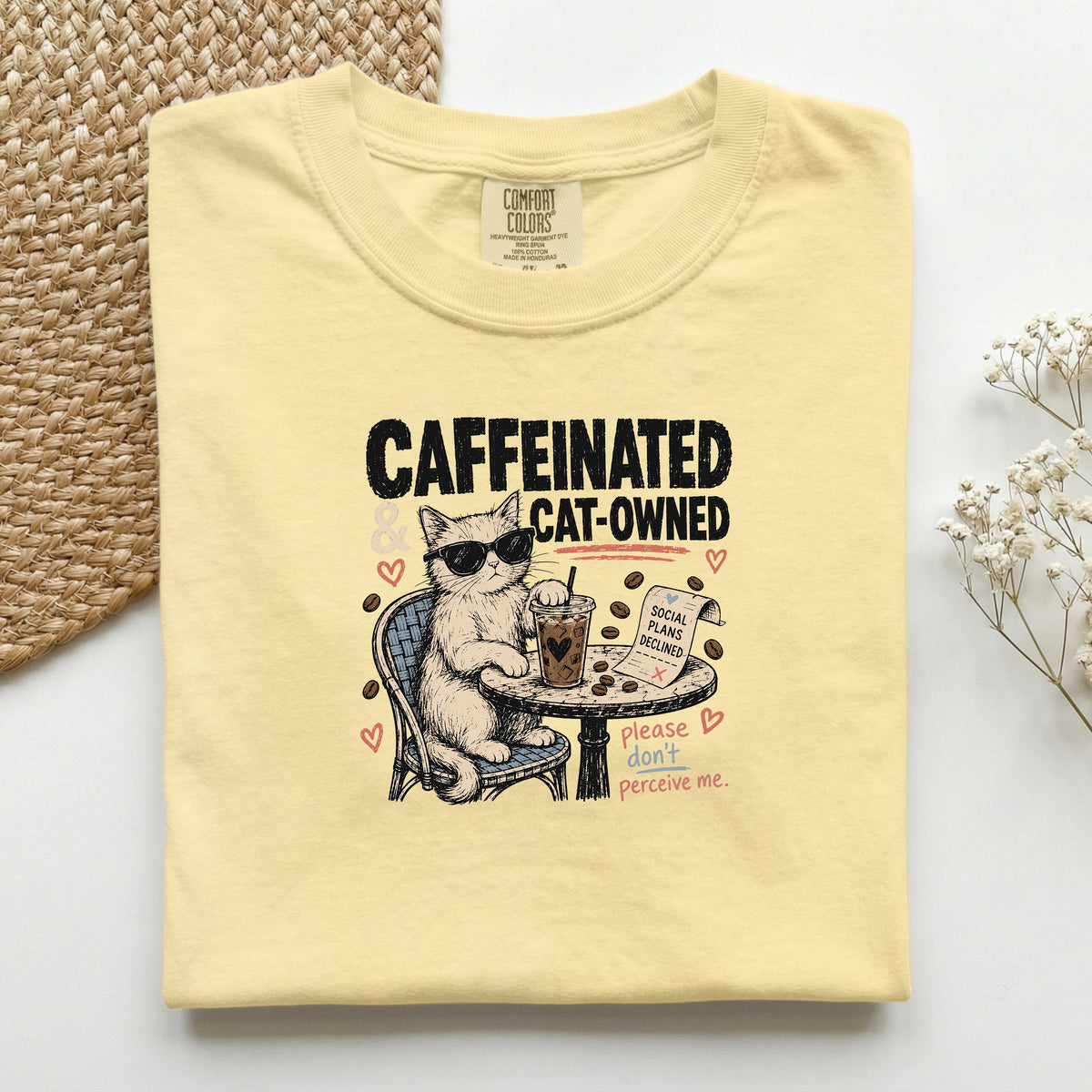Caffeinated and Cat Owned graphic tee in Butter, folded flat lay