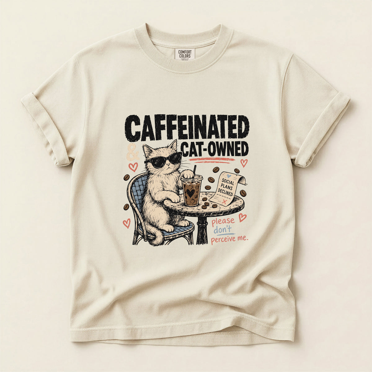 Caffeinated and Cat Owned graphic tee in Ivory, folded flat lay