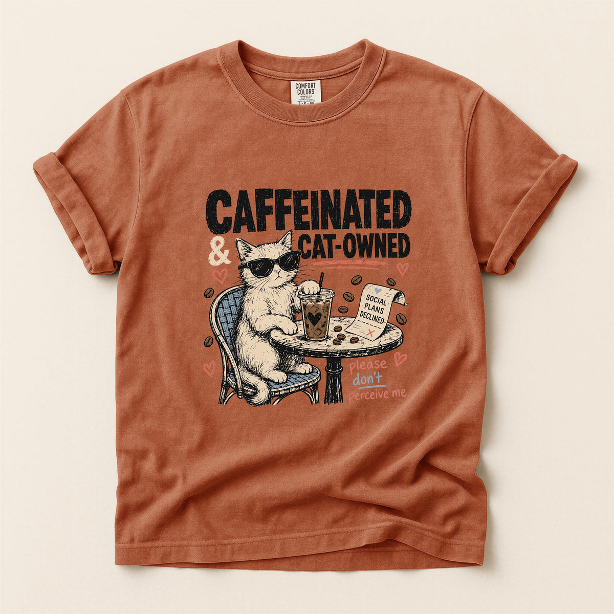 Caffeinated and Cat Owned graphic tee in Yam, folded flat lay