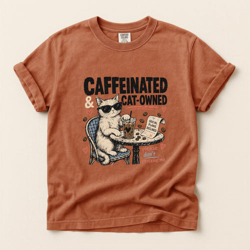 Caffeinated and Cat Owned graphic tee in Yam, folded flat lay