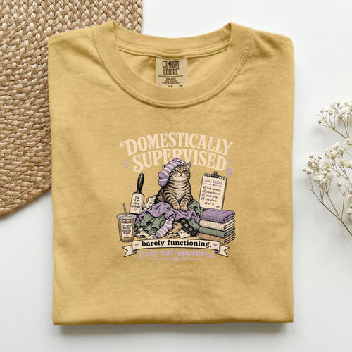 Domestically Supervised graphic tee in Mustard, folded flat lay