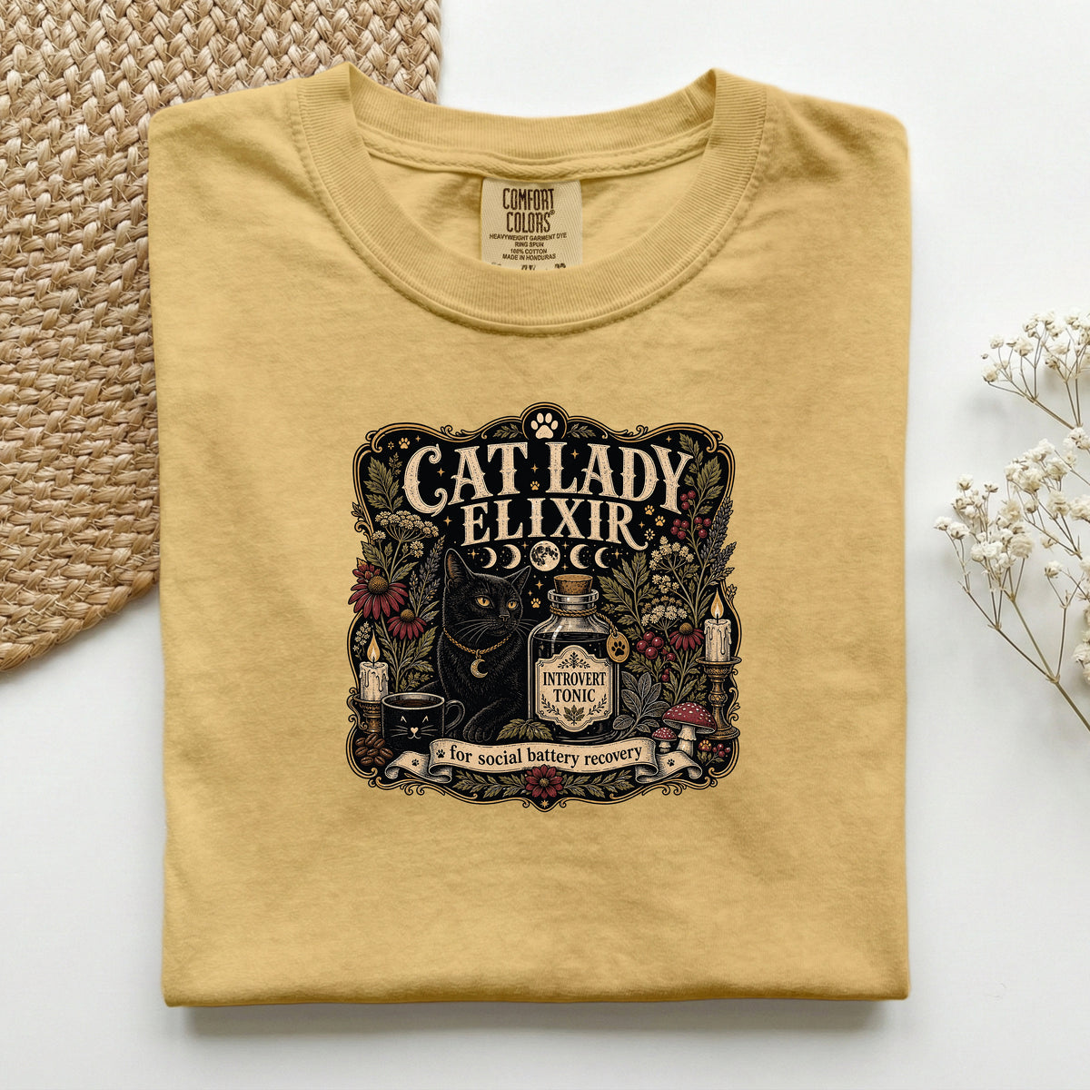 Cat Lady Elixir graphic tee in Mustard, folded flat lay