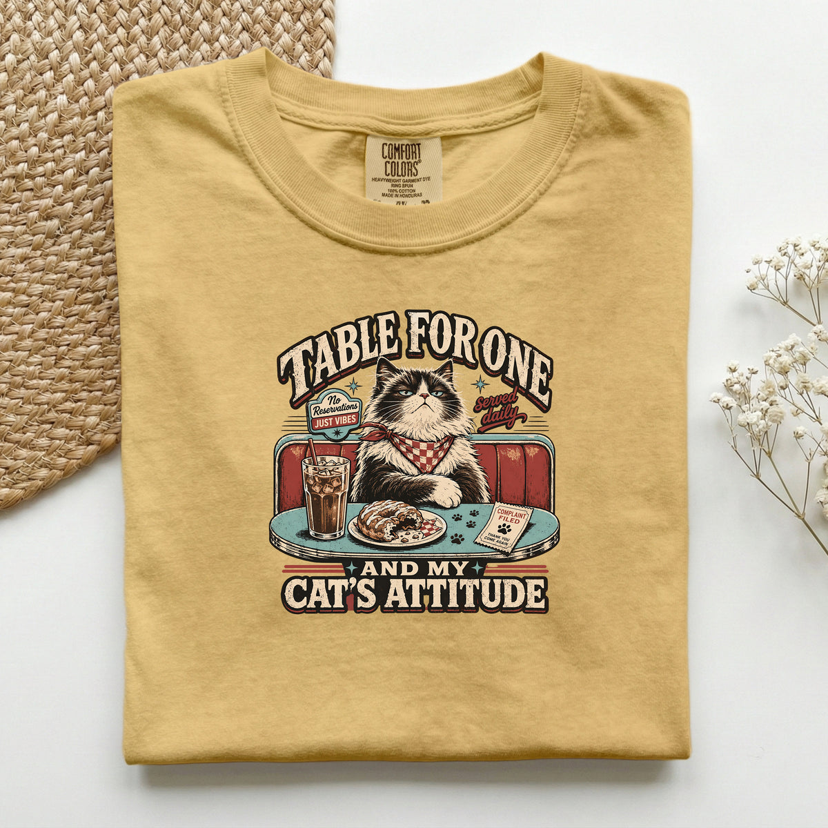 Table For One graphic tee in Mustard, folded flat lay