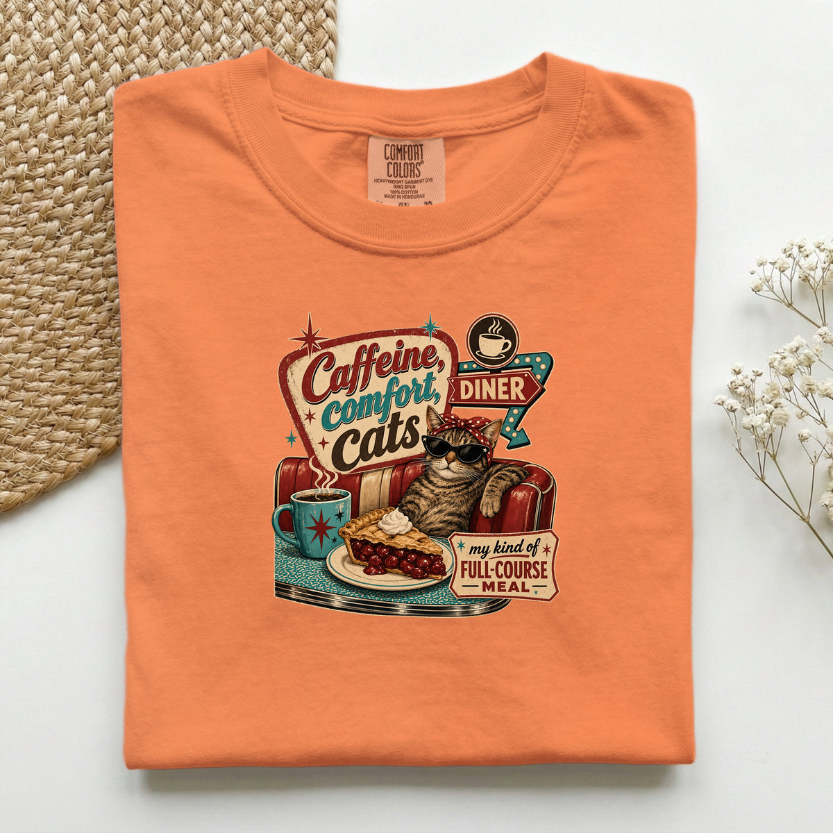 Caffeine Comfort Cats graphic tee in Burnt Orange, folded flat lay