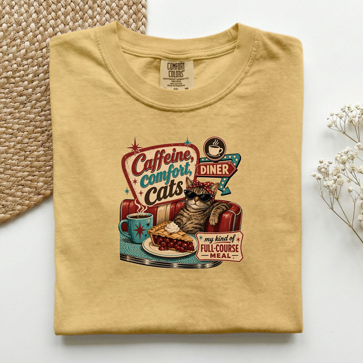 Caffeine Comfort Cats graphic tee in Mustard, folded flat lay