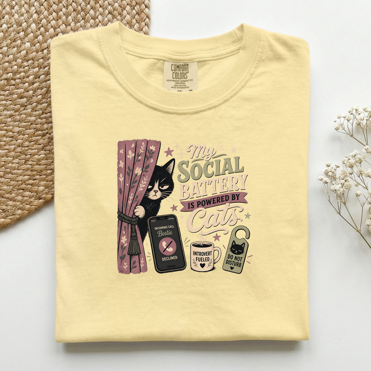 My Social Battery Is Powered By Cats graphic tee in Butter, folded flat lay