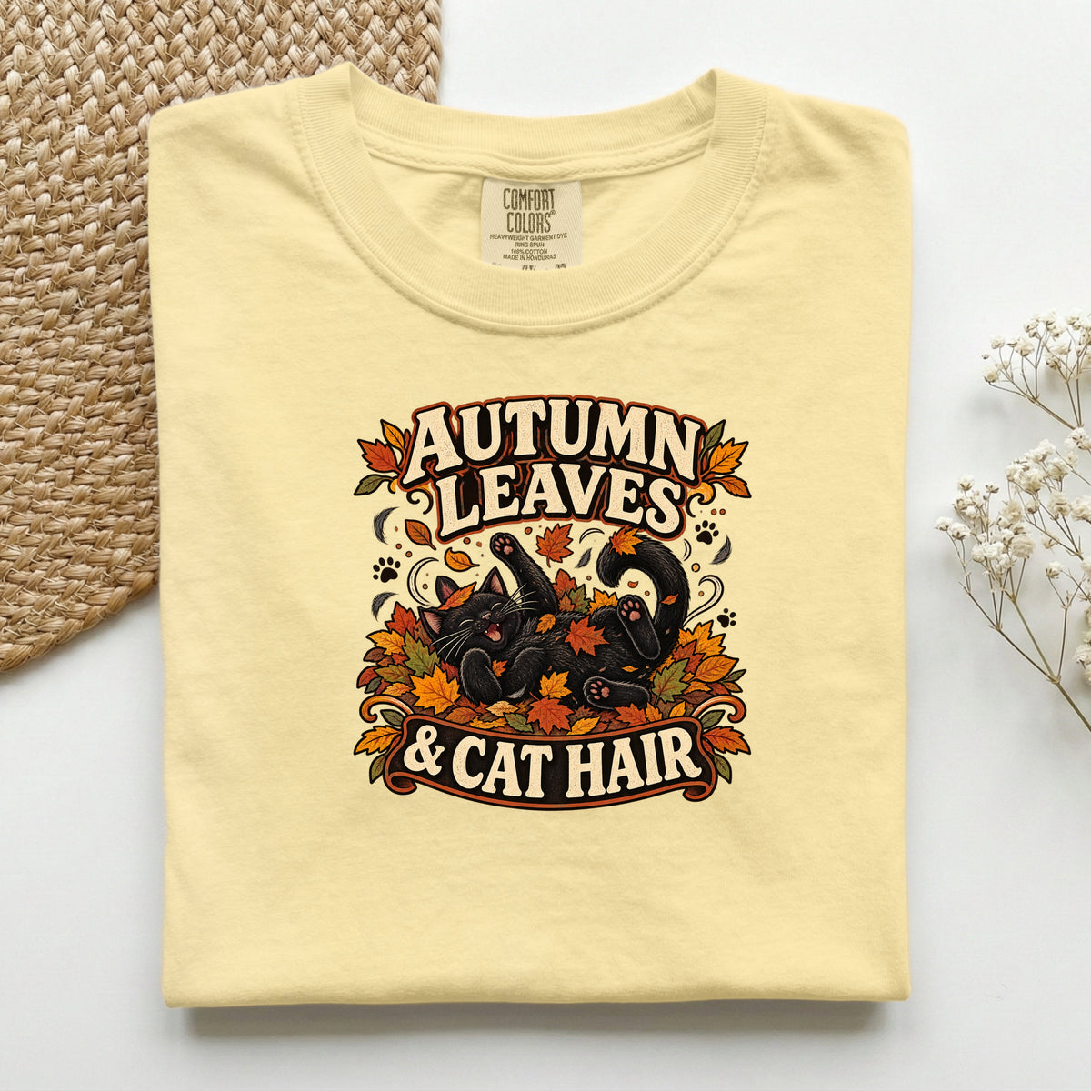 Autumn Leaves & Cat Hair graphic tee in Butter, folded flat lay