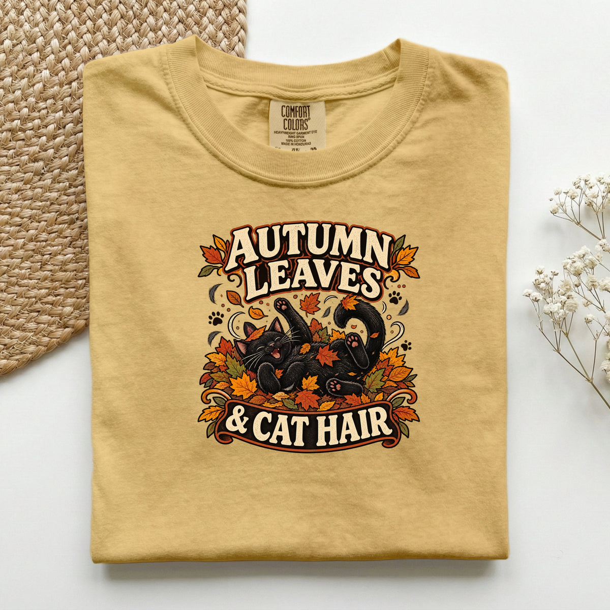 Autumn Leaves & Cat Hair graphic tee in Mustard, folded flat lay