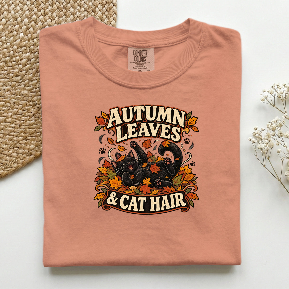 Autumn Leaves & Cat Hair graphic tee in Terracotta, folded flat lay