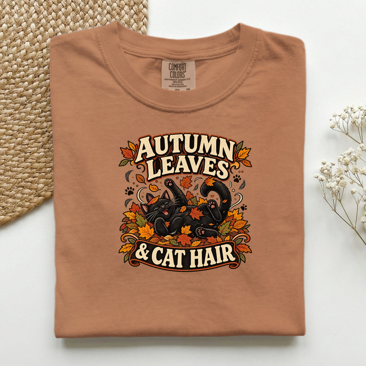 Autumn Leaves & Cat Hair graphic tee in Yam, folded flat lay