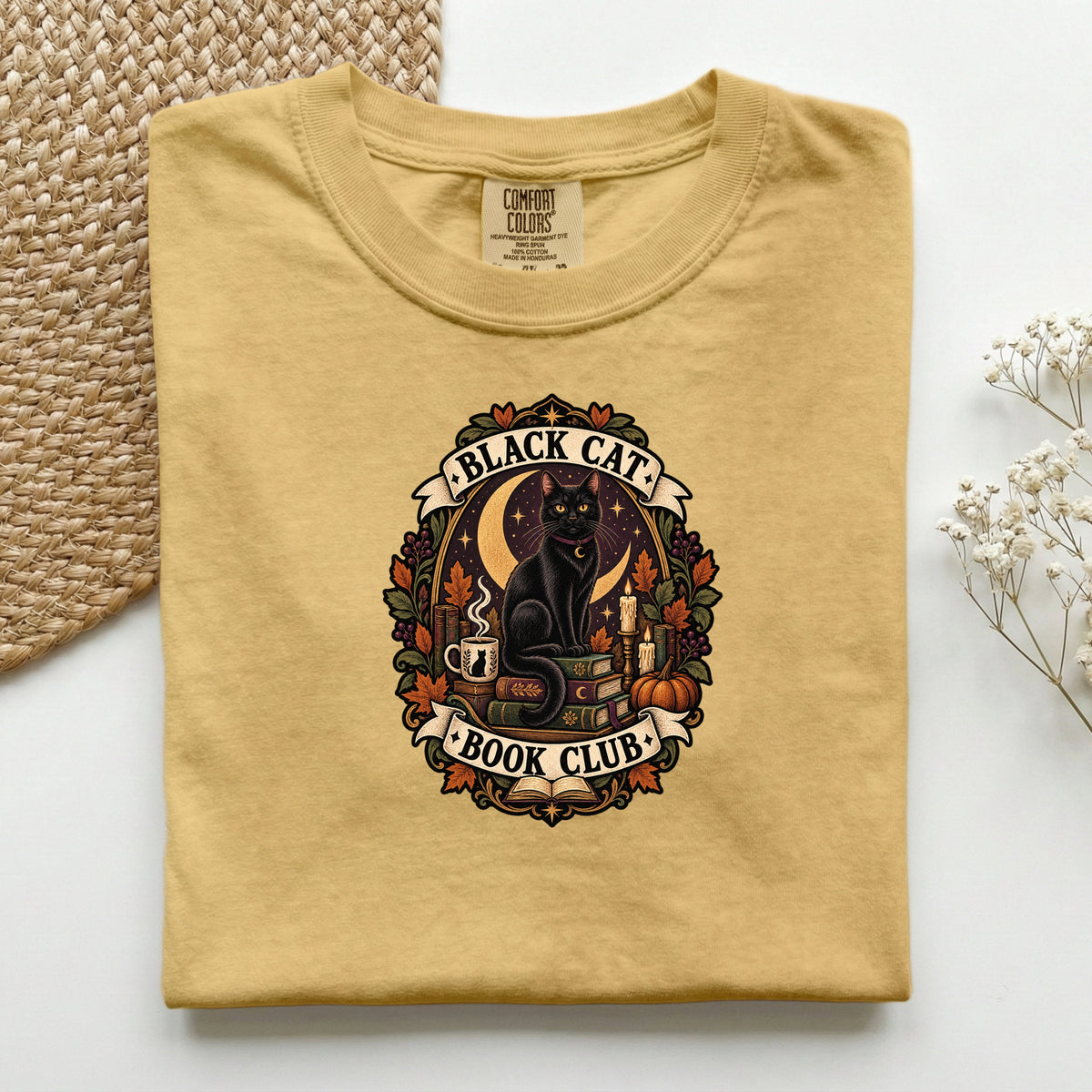 Black Cat Book Club graphic tee in Mustard, folded flat lay