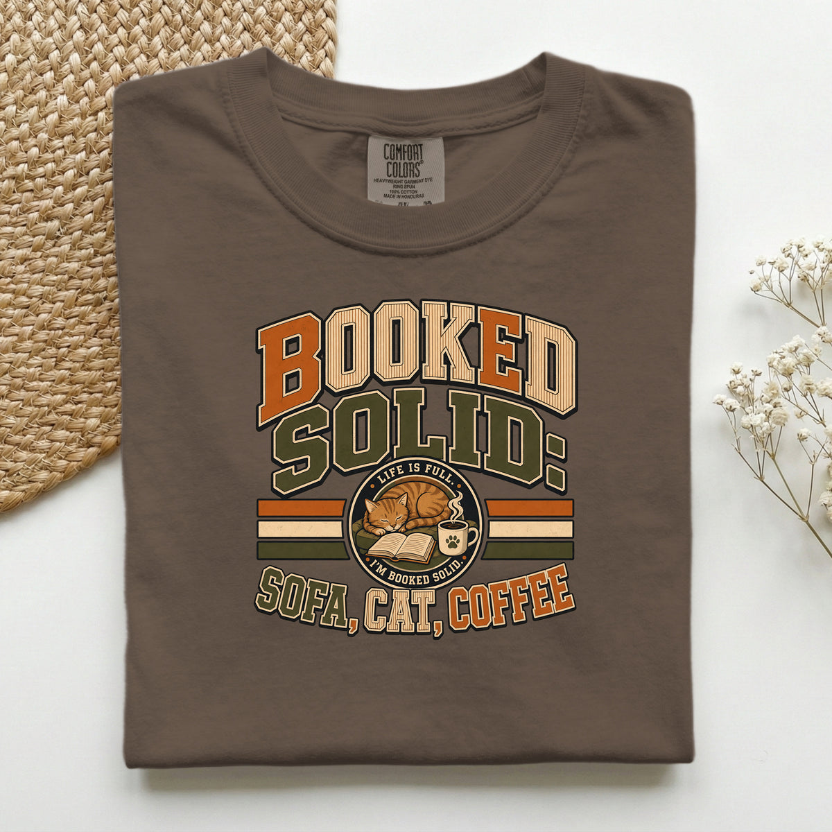 Booked Solid Sofa Cat Coffee graphic tee in Espresso, folded flat lay
