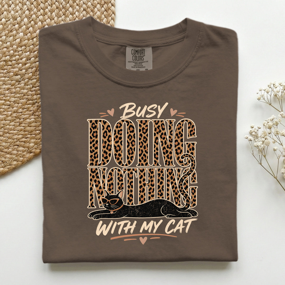 Busy Doing Nothing With My Cat graphic tee in Espresso, folded flat lay