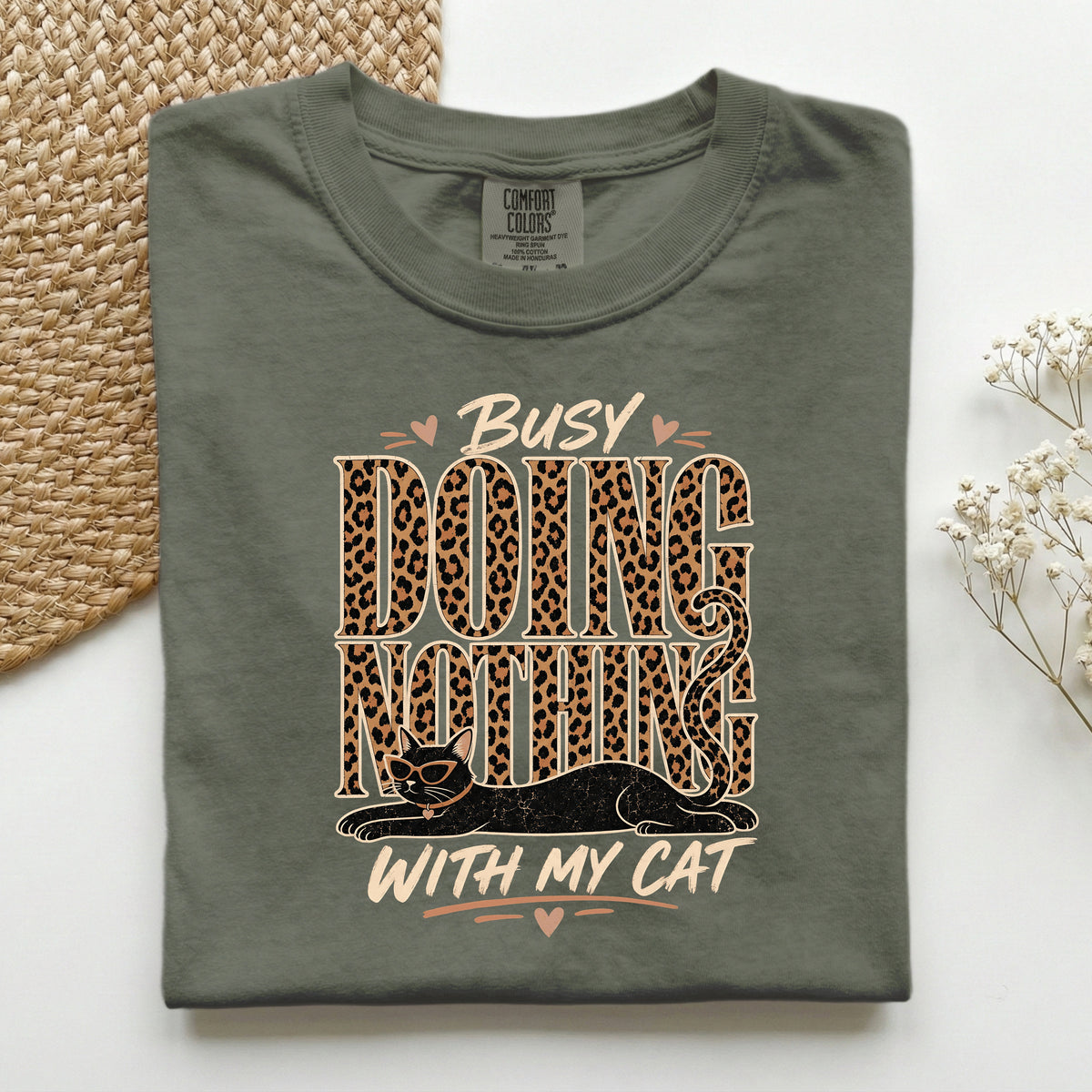 Busy Doing Nothing With My Cat graphic tee in Moss, folded flat lay