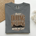 Busy Doing Nothing With My Cat graphic tee in Pepper, folded flat lay