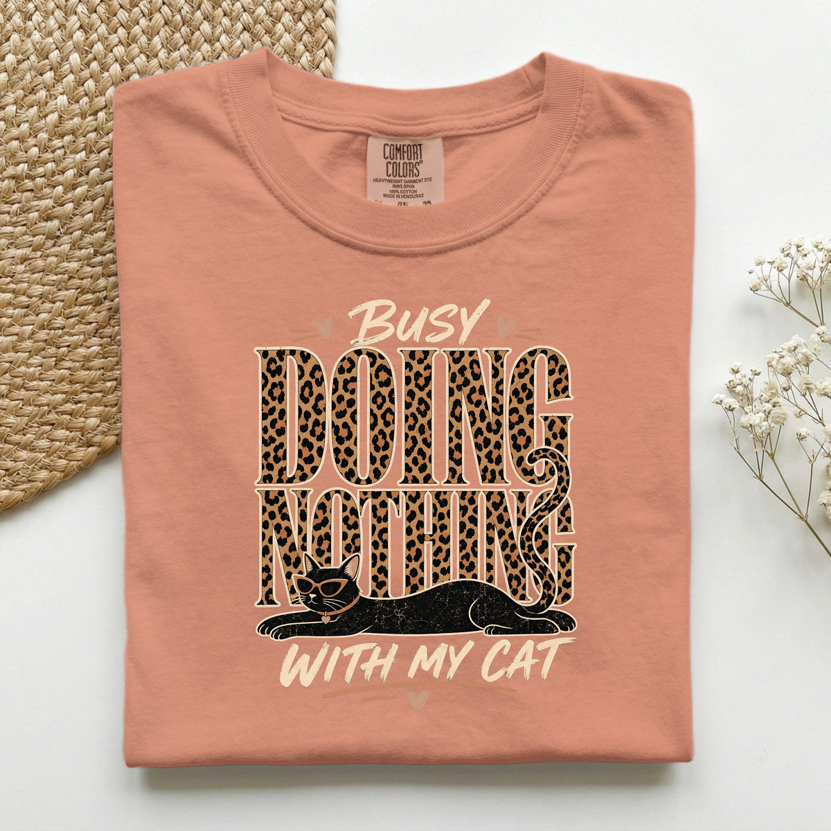 Busy Doing Nothing With My Cat graphic tee in Terracotta, folded flat lay