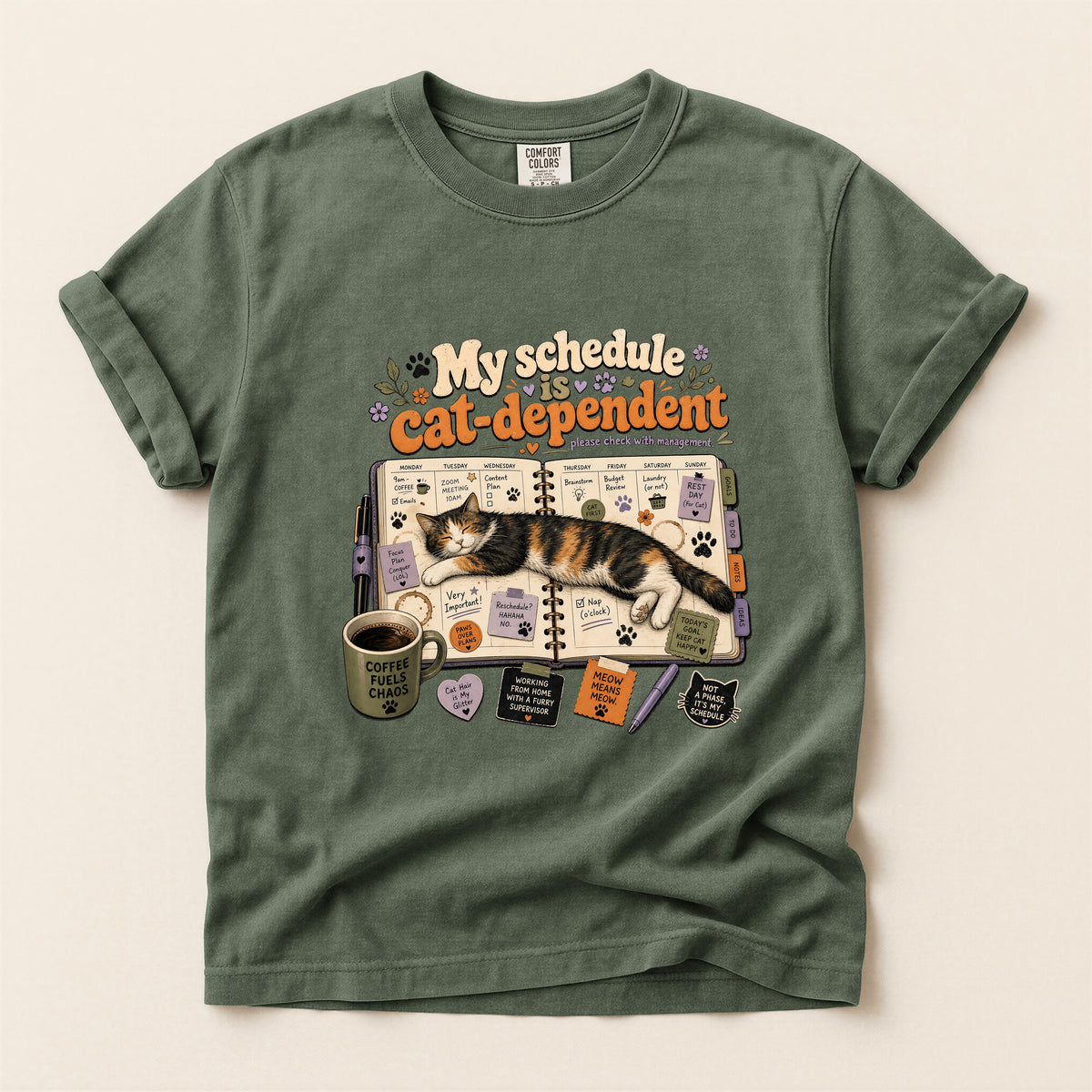 Cat Dependent Schedule graphic tee in Moss, folded flat lay