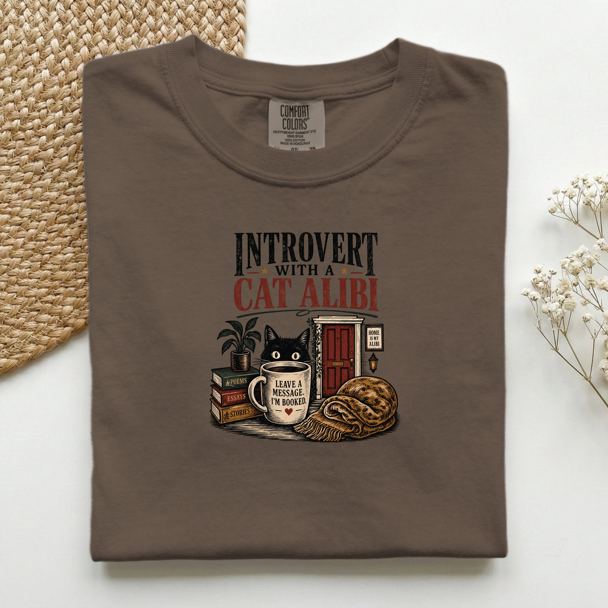 Introvert With A Cat Alibi graphic tee in Espresso, folded flat lay