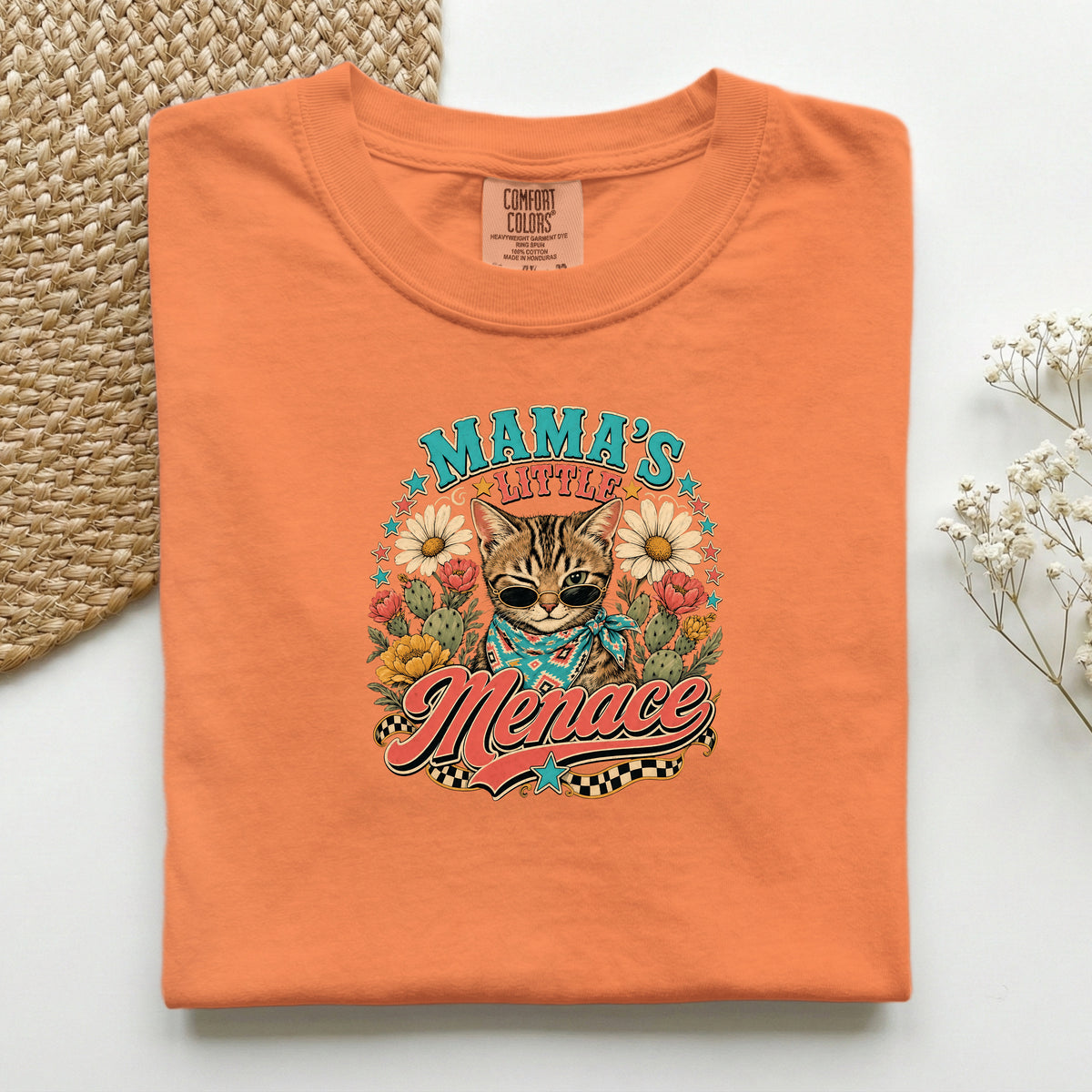 Mama's Little Menace graphic tee in Burnt Orange, folded flat lay