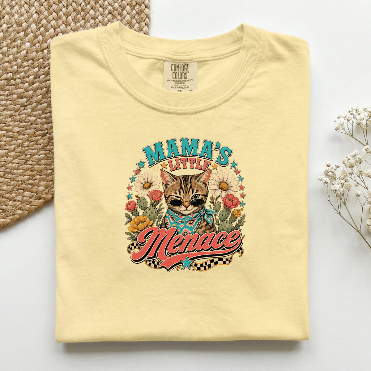 Mama's Little Menace graphic tee in Butter, folded flat lay