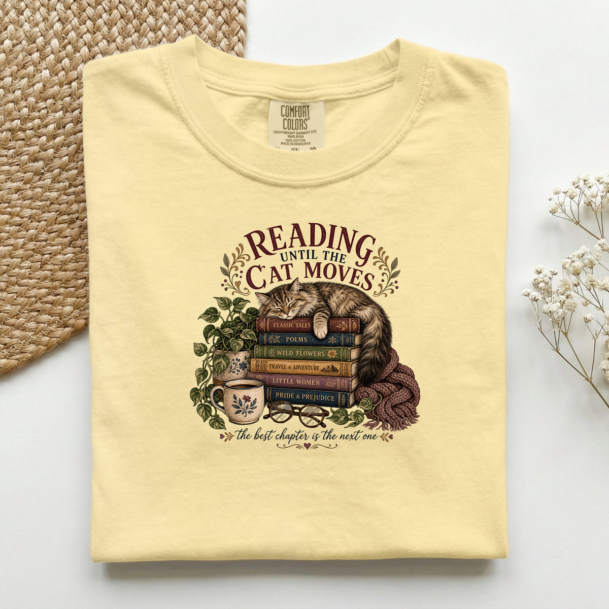 Reading Until The Cat Moves graphic tee in Butter, folded flat lay