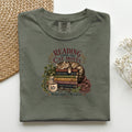 Reading Until The Cat Moves graphic tee in Moss, folded flat lay