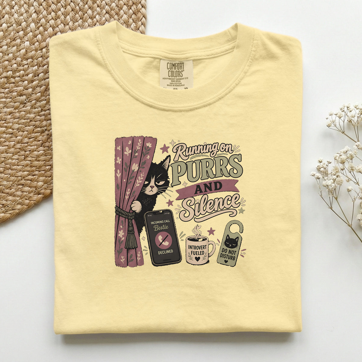 Running on Purrs and Silence graphic tee in Butter, folded flat lay