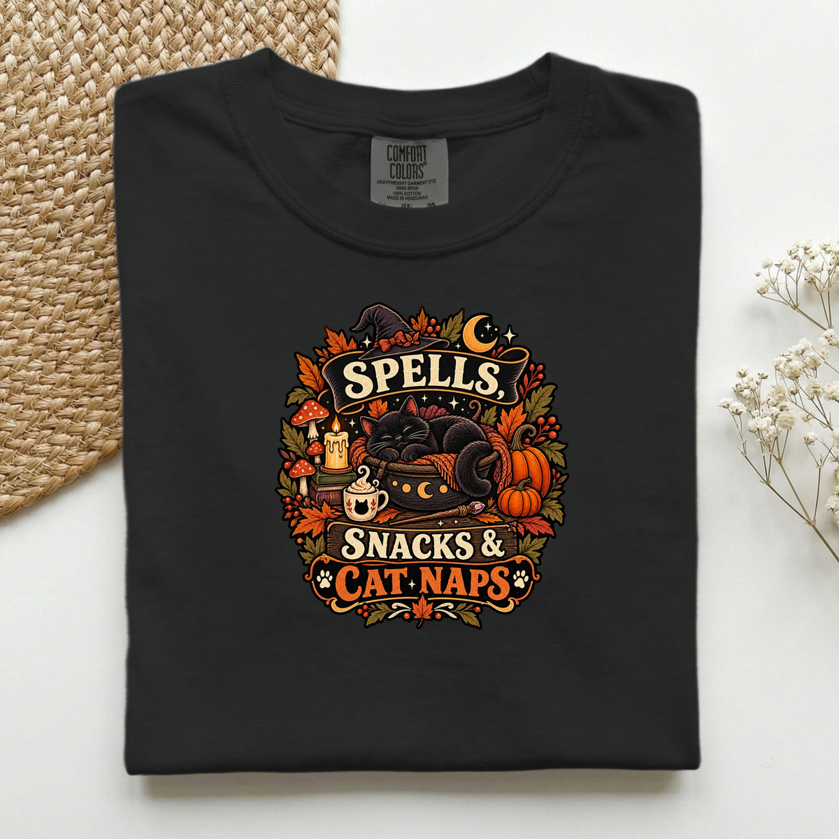 Spells Snacks & Cat Naps graphic tee in Black, folded flat lay