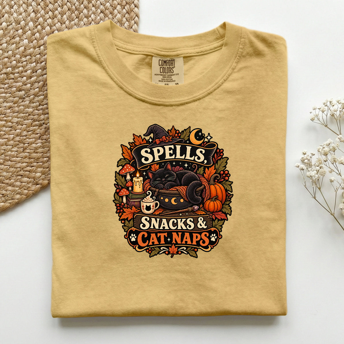 Spells Snacks & Cat Naps graphic tee in Mustard, folded flat lay