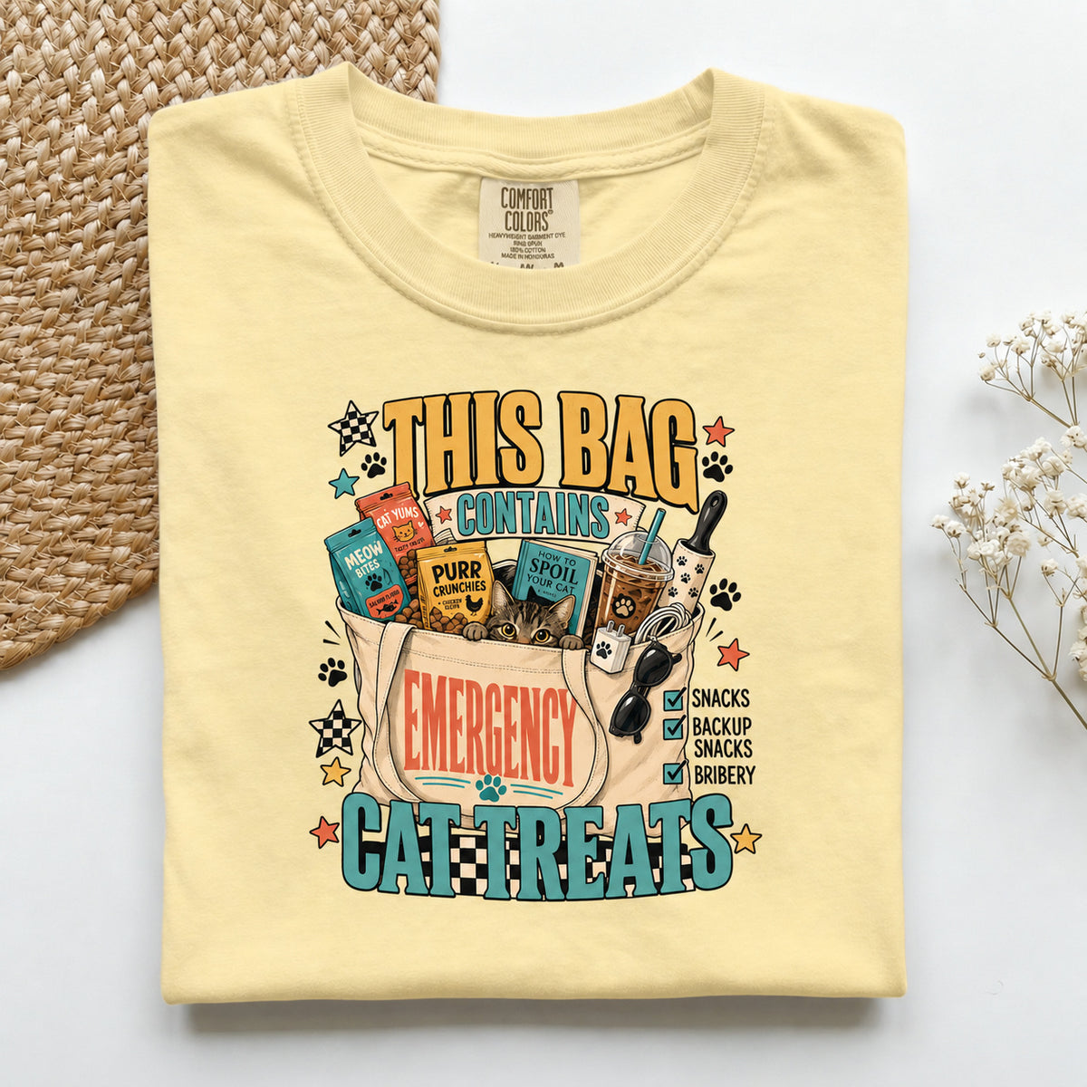 This Bag Contains Emergency Cat Treats graphic tee in Butter, folded flat lay