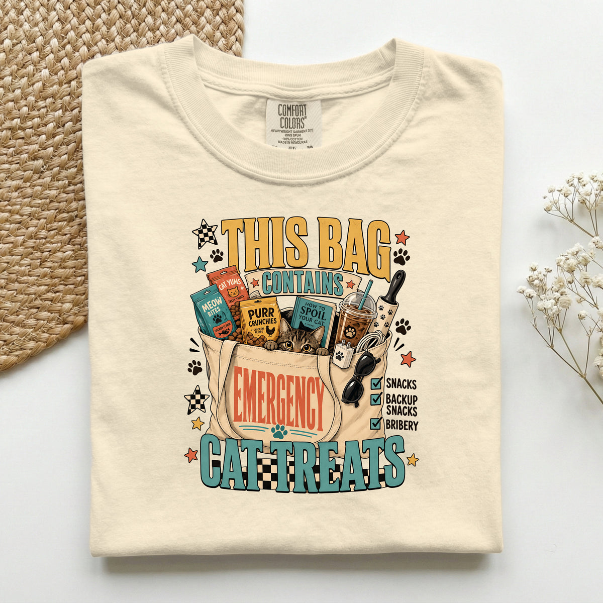 This Bag Contains Emergency Cat Treats graphic tee in Ivory, folded flat lay